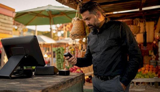 Retail manager inspecting POS terminal