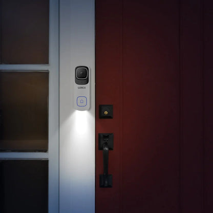 Smart doorbell with light on a red door