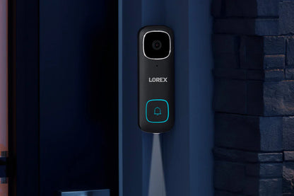 Lorex doorbell on a blue door with stone wall background